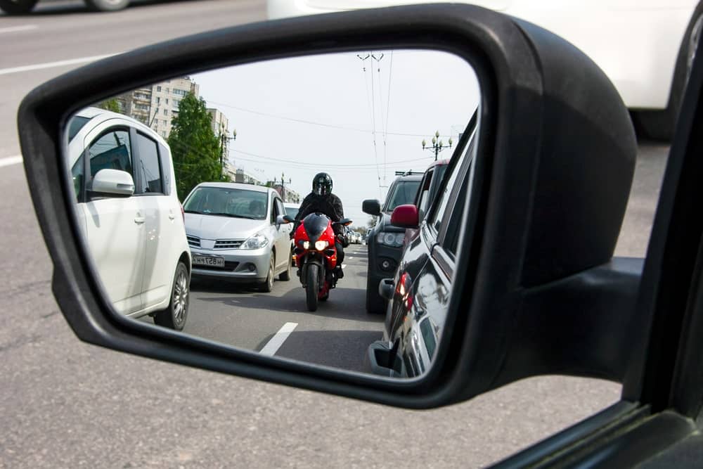 View Of A Motorcycle Driving In A Side Mirror, photo used on the Casares Injury Law website, Castle Rock car accident attorneys