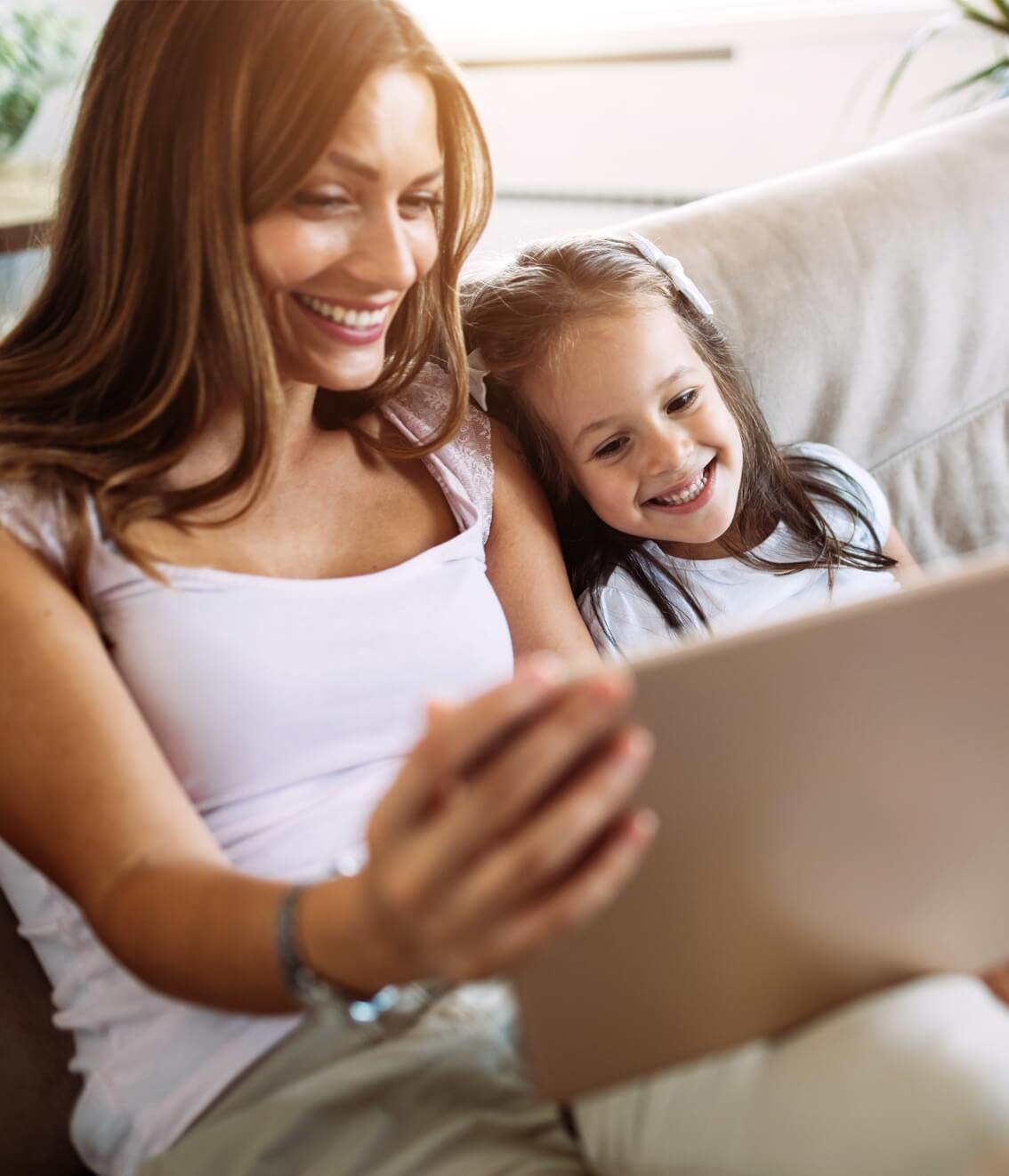 A photo of a mom and daughter on the computer smiling used on the Casares Injury Law's website, Castle Rock car accident lawyers